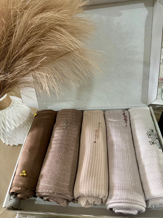 “Five cotton hijabs in gentle, natural shades, neatly packed in a gift box.”